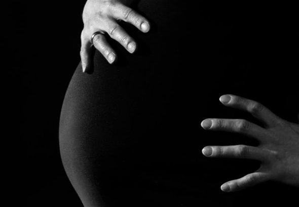 Gray Scale Photo of a Pregnant Woman